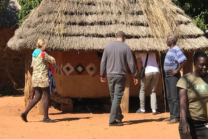 Visitors gathered outside a decorated thatched village hut