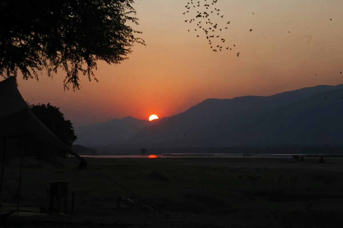 Sun setting over a river in Botswana